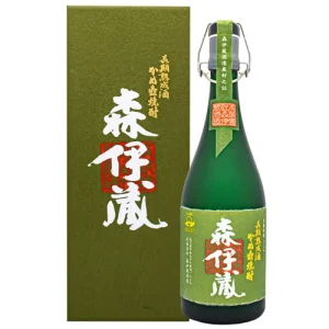 Green bottle of sake with a matching green label and white calligraphic characters, placed beside a tall green gift box.