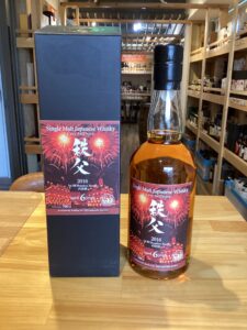 Bottle of Single Malt Japanese Whisky with black box labeled 2016 aged 6 years displayed beside its box in a liquor shop