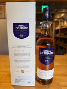 Bottle of Royal Lochnagar 12 year old Highland Single Malt Scotch Whisky beside its white box with blue label text visible ROYAL LOCHNAGAR 12 years etc