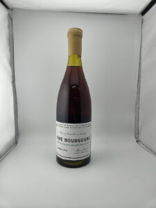 Wine bottle upright in a white display box label reads Fine Bourgogne vintage 1979 with a wax sealed cork