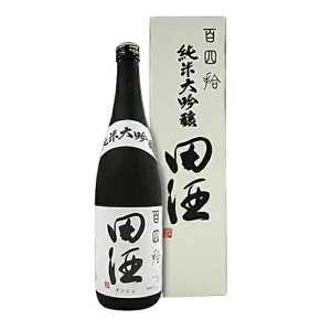 Bottle of Japanese sake with a white label featuring bold kanji, placed beside a tall white box with matching characters.