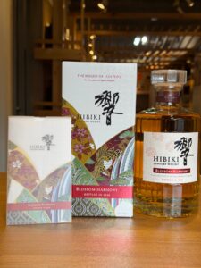 Box and bottle of Hibiki Suntory Whisky Blossom Harmony displayed on a wooden surface.