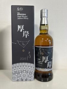 Box and bottle of The Akkeshi Single Blended Japanese Whisky, dark packaging with Japanese characters, bottle with silver neck wrap beside it.