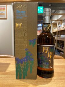 Box and bottle of Akkeshi single malt Japanese whisky (peaty) with blue iris artwork on the packaging.