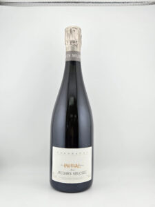 Champagne bottle with a silver foil top and white label reading Jacques Selosse photographed upright against a light background