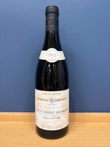 Wine bottle labeled Domaine Chevillon Nuits Saint Georges 2022 on a wooden table