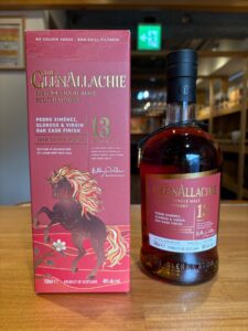 Pink box and bottle of The GlenAllachie 13 Year Old Speyside single malt whisky gold lettering rearing horse illustration and Year of the Horse inscription