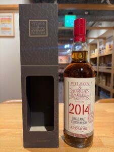 Bottle of Wilson  Morgan Barrel Selection 2014 single malt Scotch whisky beside its dark box on a wooden surface