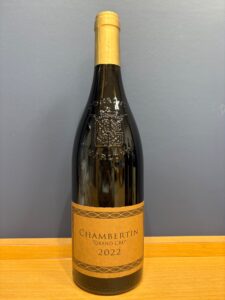 nj1WZ9VKYhneqaQUSdeIYAJ0hD4pXuuNdcR76k8J お酒買取専門店LIQUORJOYリカージョイ Bottle of Chambertin Grand Cru 2022 champagne with gold foil neck and embossed crest standing on a wooden surface against a gray background