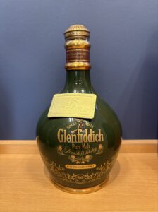 Close up of a Glenfiddich whiskey bottle neck with a gold cap and 18 years old tag visible on the label